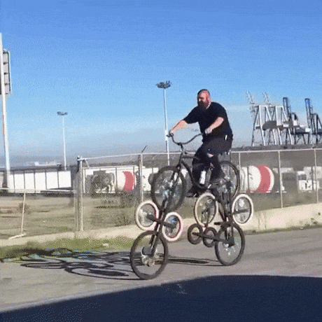 This is a man riding several bikes at once