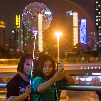 Girls with glowing sphere taking a selfie