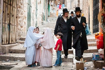 Orthodox Jewish men and Muslim children