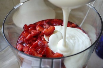 Add yogurt to strawberries and whirl