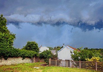 France (Essonne). White houses under a Stormy sky. Lightning will soon strike !